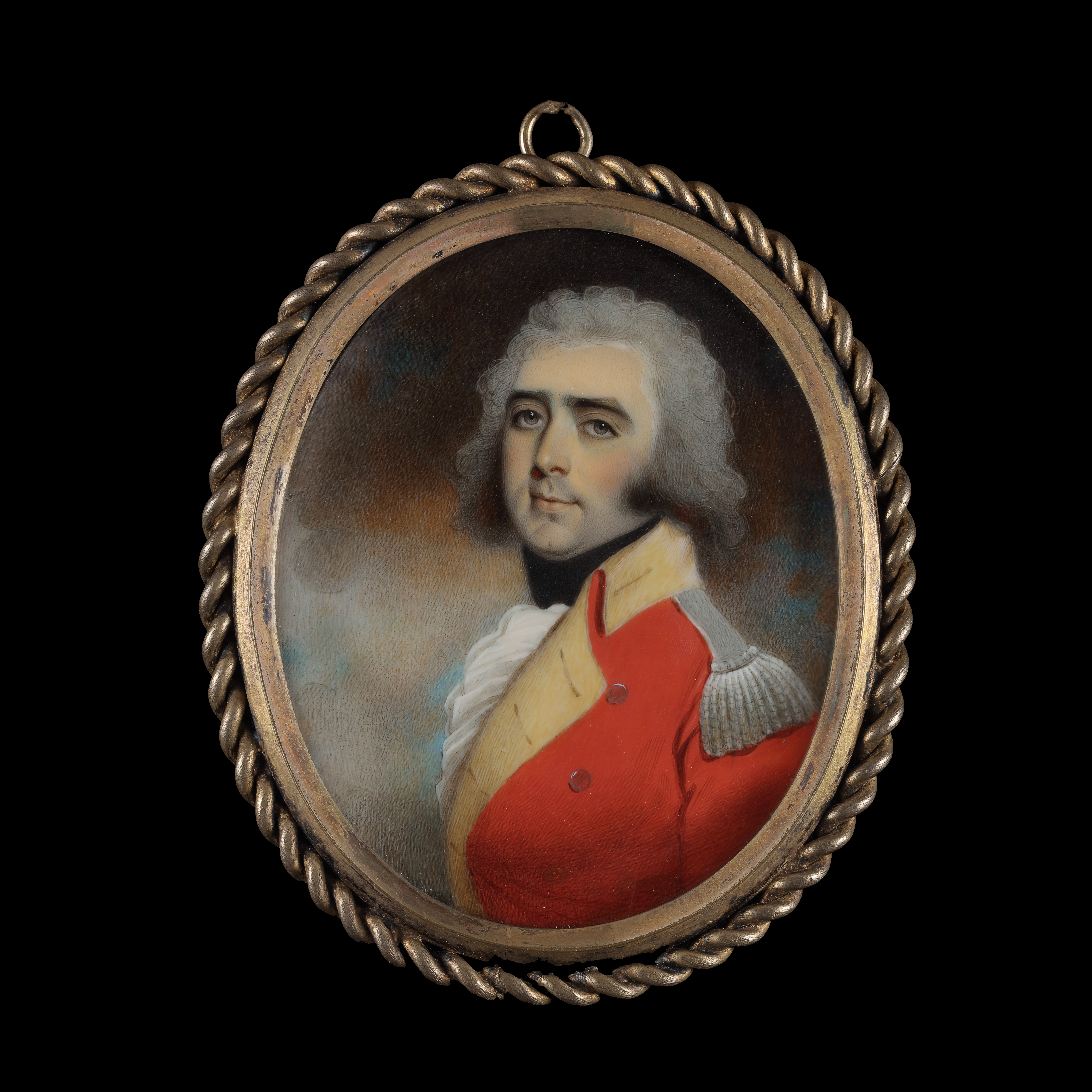 Portrait miniature of an Officer, wearing scarlet coat with yellow facings and silver epaulettes, black stock and white cravat, his hair powdered